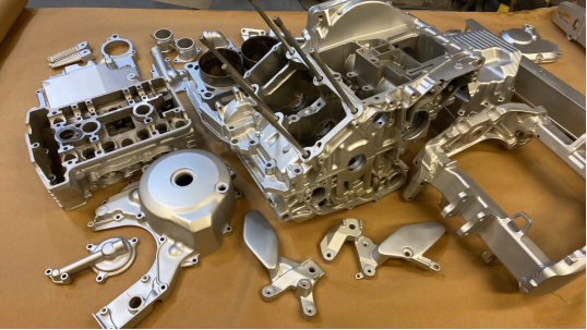 Pistons in an engine block coated with a ceramic layer