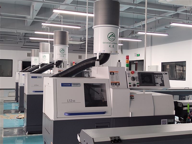 Modern Industrial Oil Mist Collector Unit in a CNC Machine Shop Environment