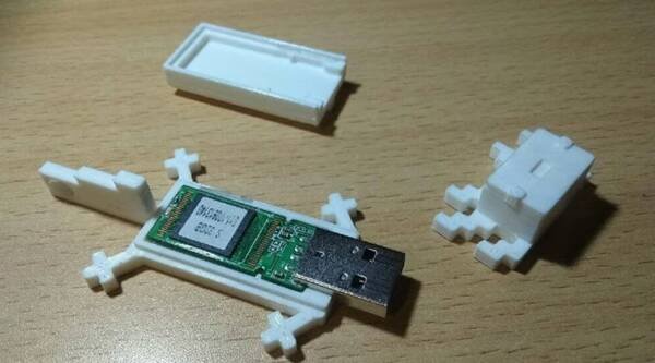 Minecraft-style axolotl figurine split horizontally, revealing USB drive storage inside