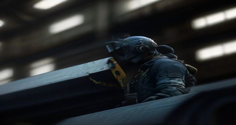 Large CNC Machining Equipment — Operator dwarfed by a massive gantry mill cutting a steel block