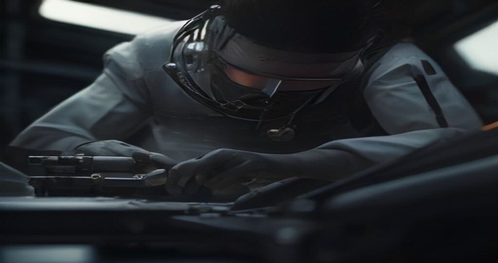 CNC Machines Online — Engineer measuring a machined steel part with calipers at a clean inspection bench